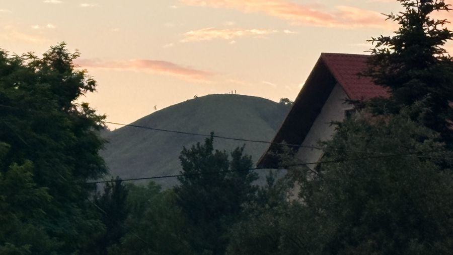Esti fény a falu melletti domb fölött